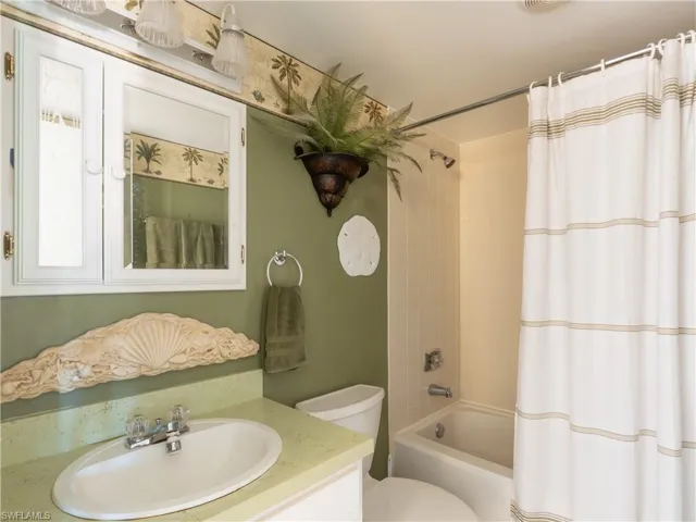 Primary bathroom featuring a dual tub and shower.