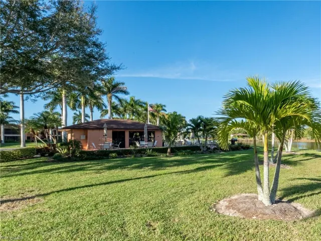 View of the property's  common space featuring  seating area, and grill.