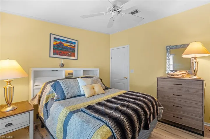 Bedroom with ceiling fan and light wood-type flooring