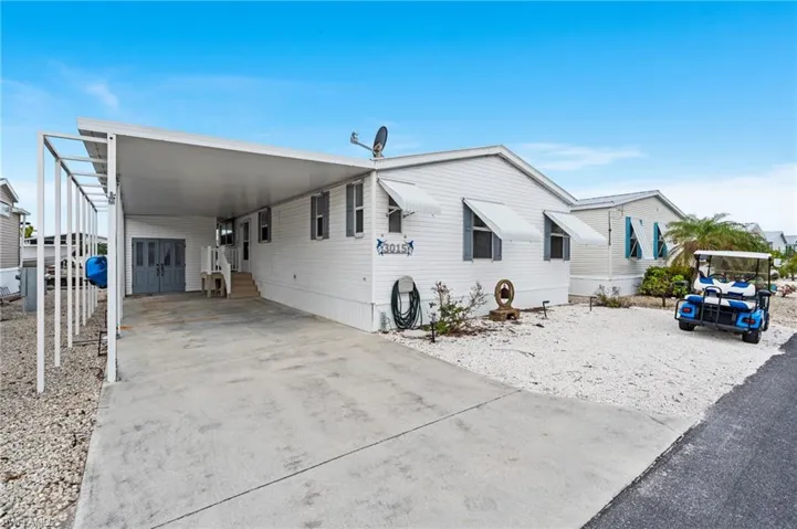 Manufactured home featuring a carport