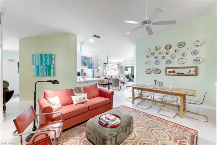 Living area featuring light tile patterned flooring and a ceiling fan