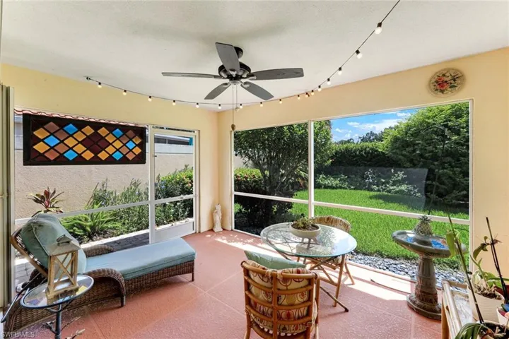 Sunroom with a ceiling fan and a textured ceiling