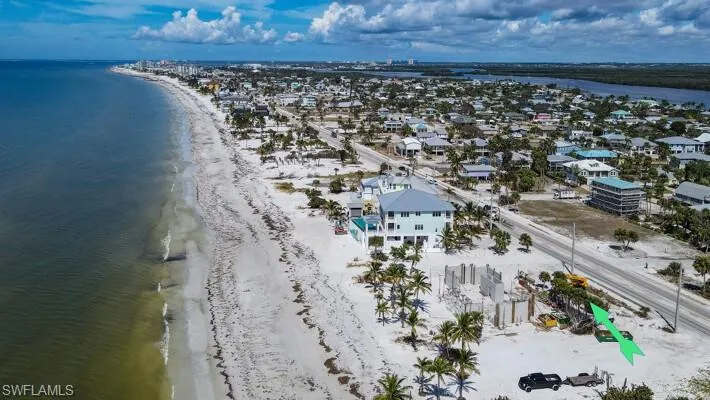 Birds eye view of property featuring a view of the beach and a water view