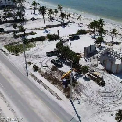 Snowy aerial view with a view of the beach and a water view