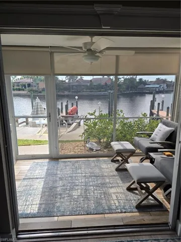 Sunroom with a water view and ceiling fan