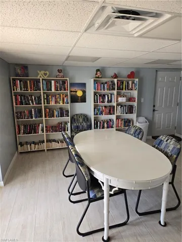 Dining area with a paneled ceiling and hardwood / wood-style floors