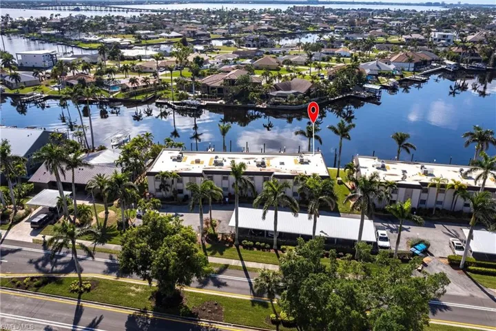 Birds eye view of property with a water view