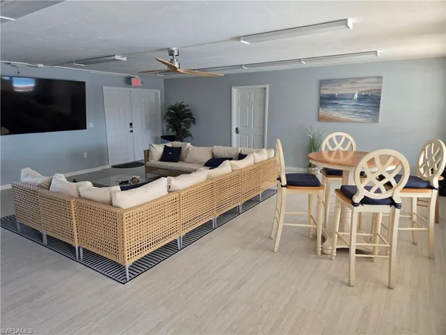 Living room with light hardwood / wood-style flooring and ceiling fan
