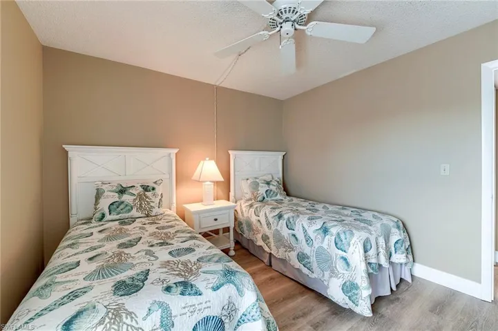 Bedroom featuring wood-finish flooring, a ceiling fan, and painted walls