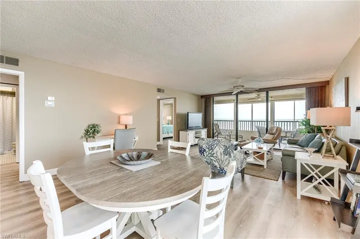 Open-concept living area featuring a light-toned wood-finish floor and a neutral wall color