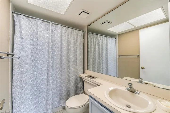 Full wall mirror above a vanity featuring an integrated sink with chrome fixtures