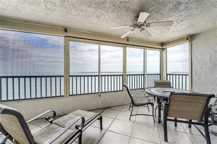 Screened balcony featuring expansive water scenery