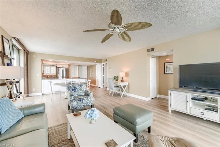 Open concept living space featuring wood-finish flooring, a ceiling fan, and recessed lighting