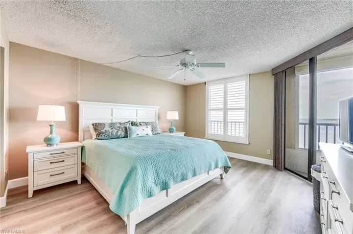 Bedroom featuring light wood-finish flooring, a ceiling fan, and painted walls