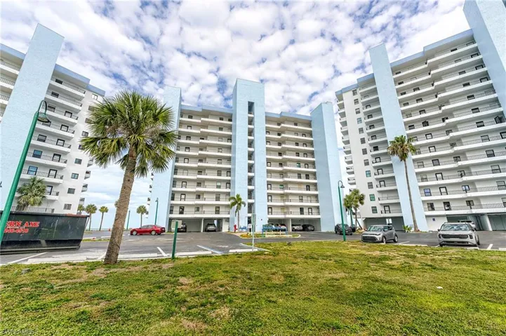 Modern high-rise residential building featuring light blue and white exterior finishes