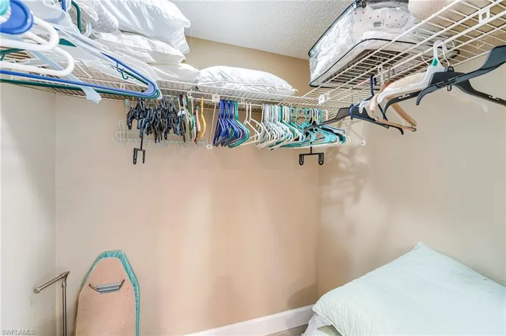 White wire shelving system with hanging rods