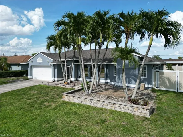 Single-story residence featuring a gray exterior with white trim and a shingled roof