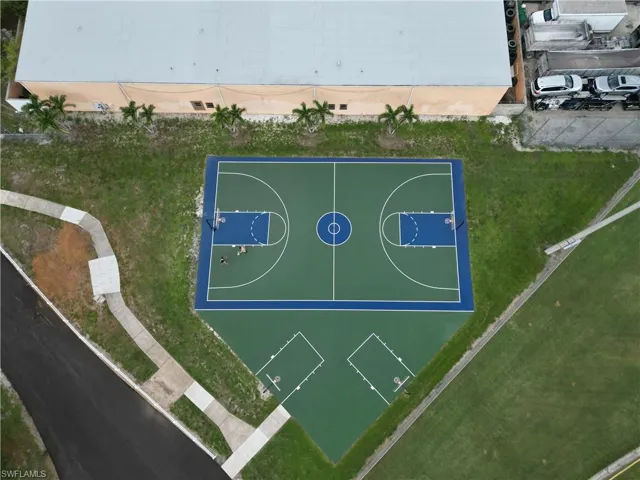 Outdoor recreational court featuring a full-size basketball court and an additional half-court area