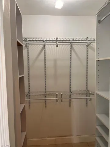 Customizable closet system with wire shelving and integrated hanging rods
