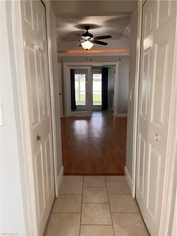 Tiled entryway leading to wood-finish flooring