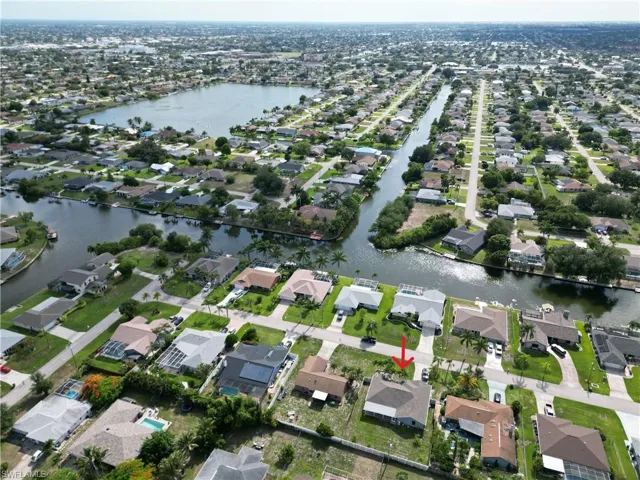 Aerial perspective showcasing a residential neighborhood with canal access