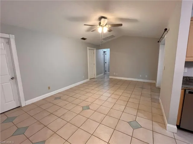 Vaulted ceiling featuring a ceiling fan with integrated lighting
