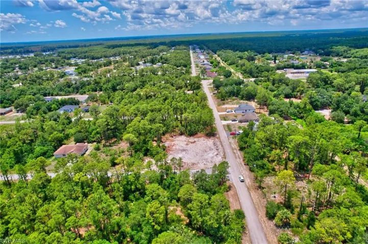 View of property location featuring a forest