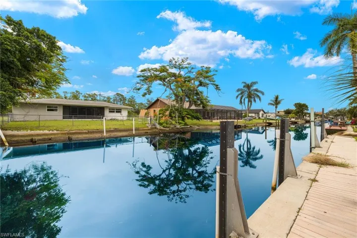 View of swimming pool with a yard and a water view