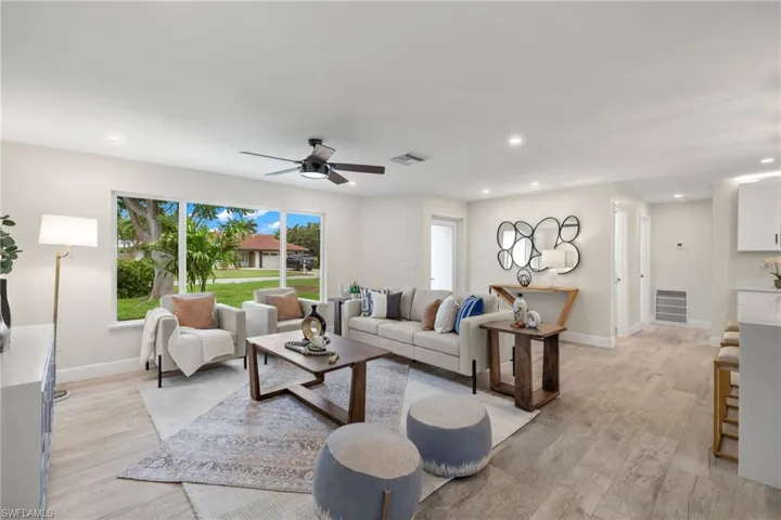 Living room featuring light hardwood / wood-style floors and ceiling fan
