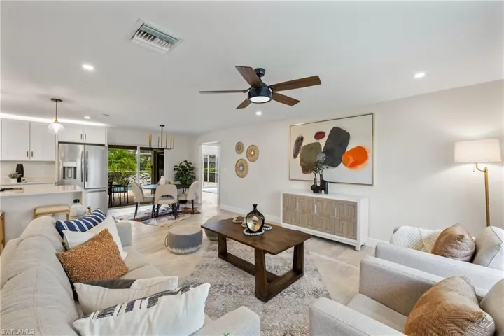 Living room with light wood-type flooring and ceiling fan