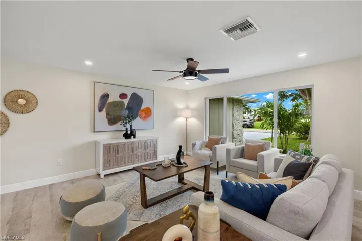 Living room featuring light hardwood / wood-style flooring and ceiling fan