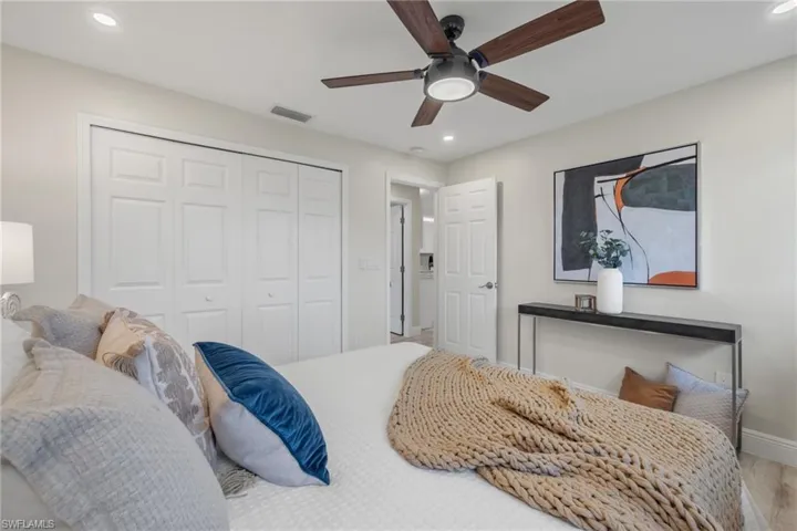 Bedroom with wood-type flooring, a closet, and ceiling fan