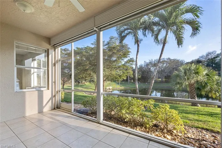 Unfurnished sunroom featuring a ceiling fan and a water view