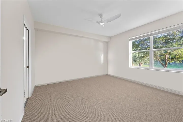 Unfurnished room with baseboards, light colored carpet, and a ceiling fan