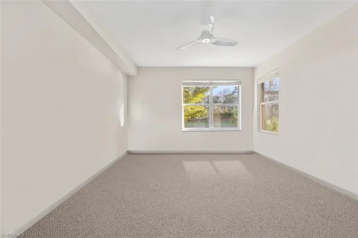 Unfurnished room featuring baseboards, carpet, and a ceiling fan