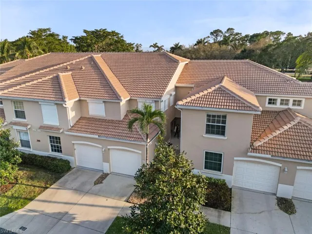 Mediterranean / spanish-style house with stucco siding, driveway, and a tile roof