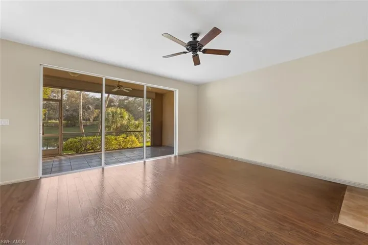 Spare room with ceiling fan, baseboards, and wood finished floors