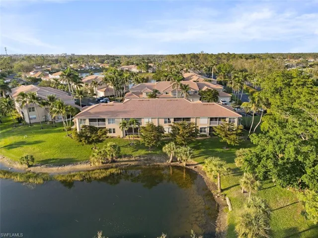 Drone / aerial view with a residential view and a water view