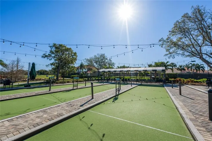 Dual bocce ball courts featuring artificial turf and paver surrounds
