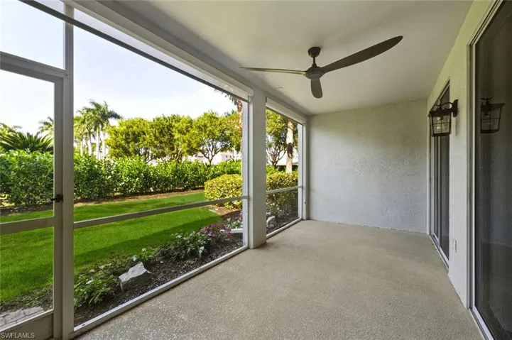 Screened patio with a ceiling fan and outdoor wall sconces