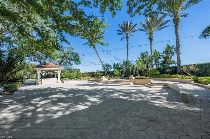 Expansive paver patio featuring a central gazebo with a tiled roof