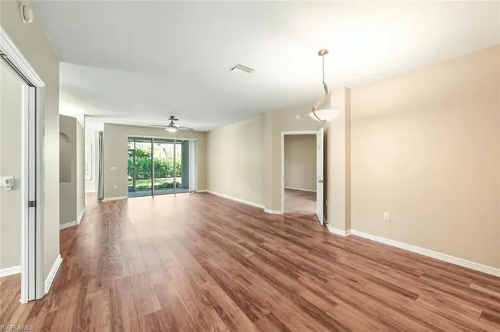 Spacious interior featuring wood-finish flooring, neutral paint palette, and sliding glass doors