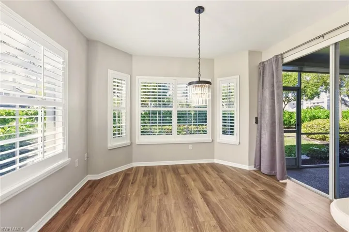 Wood-finish flooring throughout, complemented by a bay window configuration with plantation shutters