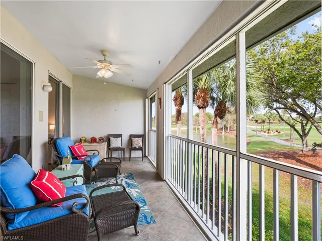 Sunroom / solarium with ceiling fan, a water view, golf course view, and a balcony