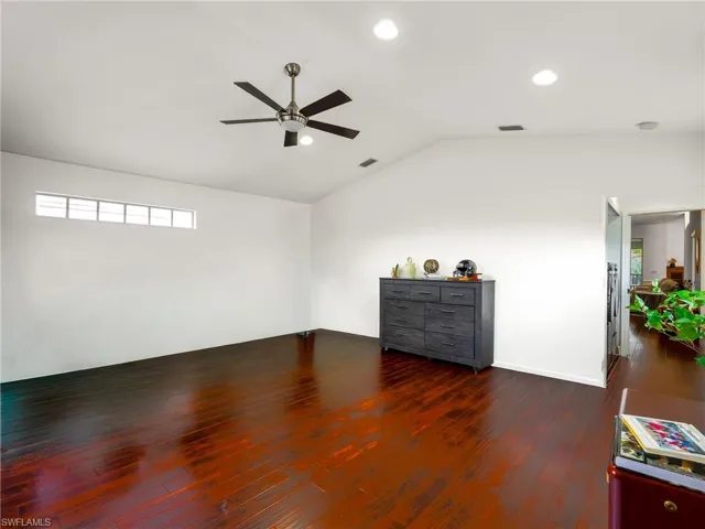 Bonus Room with dark wood finished floors, ceiling fan, vaulted ceiling, and recessed lighting