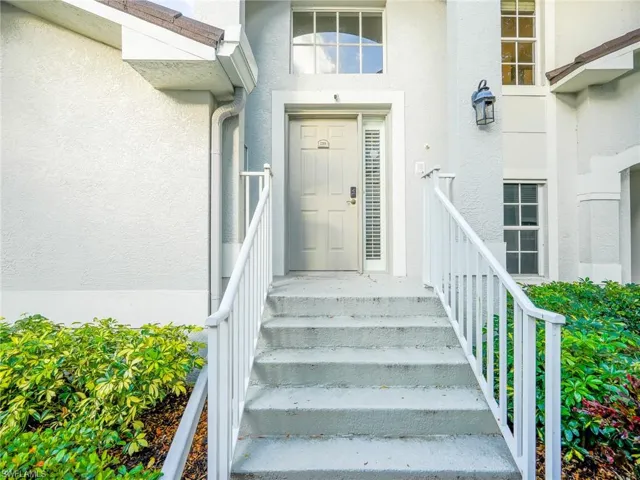 Entrance to property featuring stucco siding