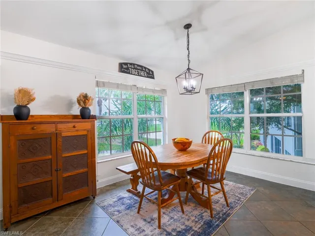 Dining room with vaulted ceiling and hanging lights
