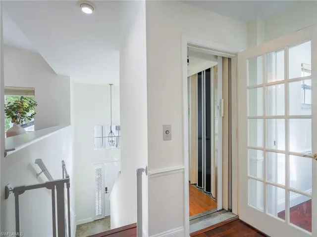 Hall featuring dark wood finished floors and elevator