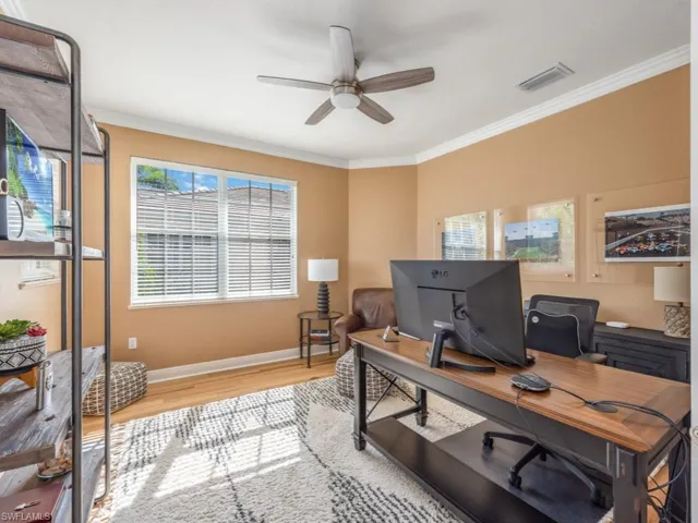 Office area with ceiling fan, light hardwood / wood-style floors, and crown molding
