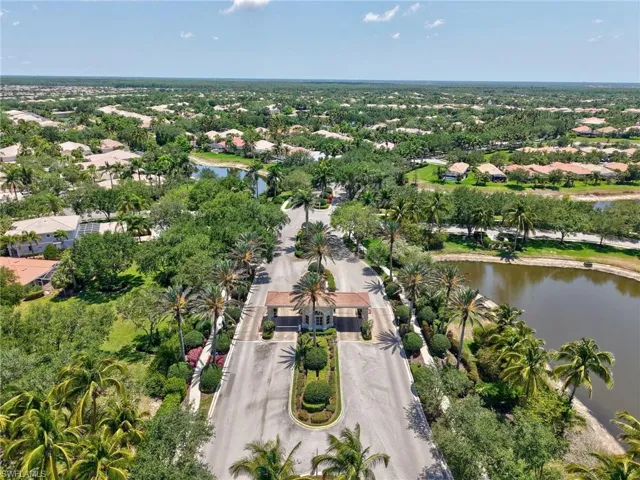 Aerial view of property and surrounding area with a nearby body of water and nearby suburban area
